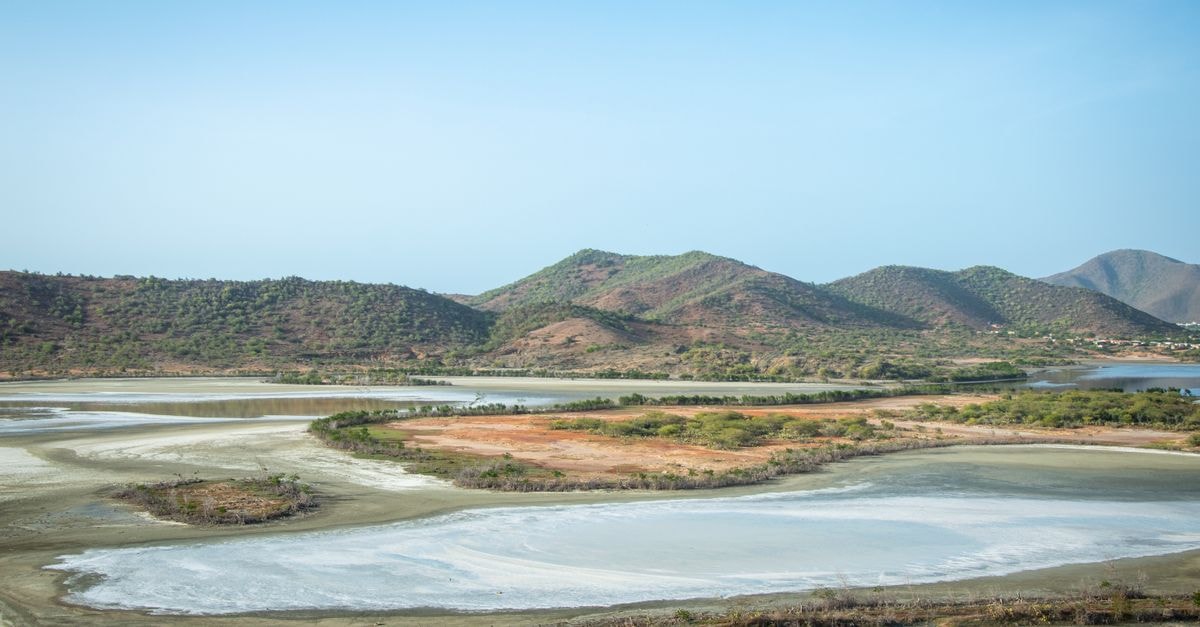 A stunning aerial landscape with sprawling hills, clear skies, and lakes reflecting the tranquility of nature.