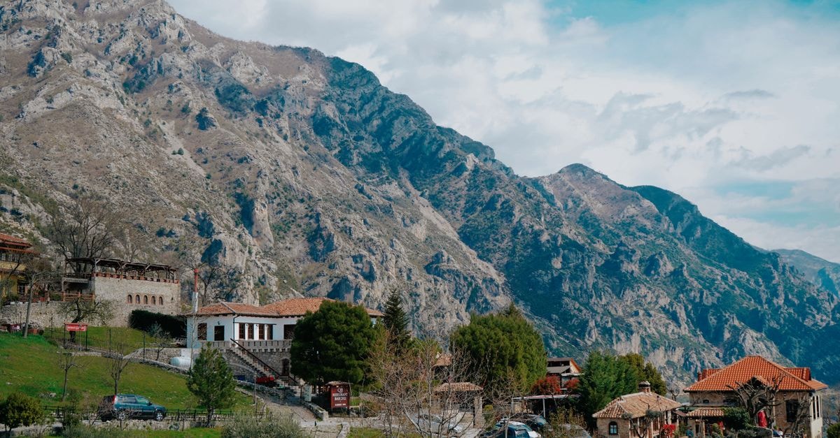 Kelar Travel Guide: Mountains, Hospitality, and Food Charming village nestled in mountainous terrain, showcasing traditional architecture.