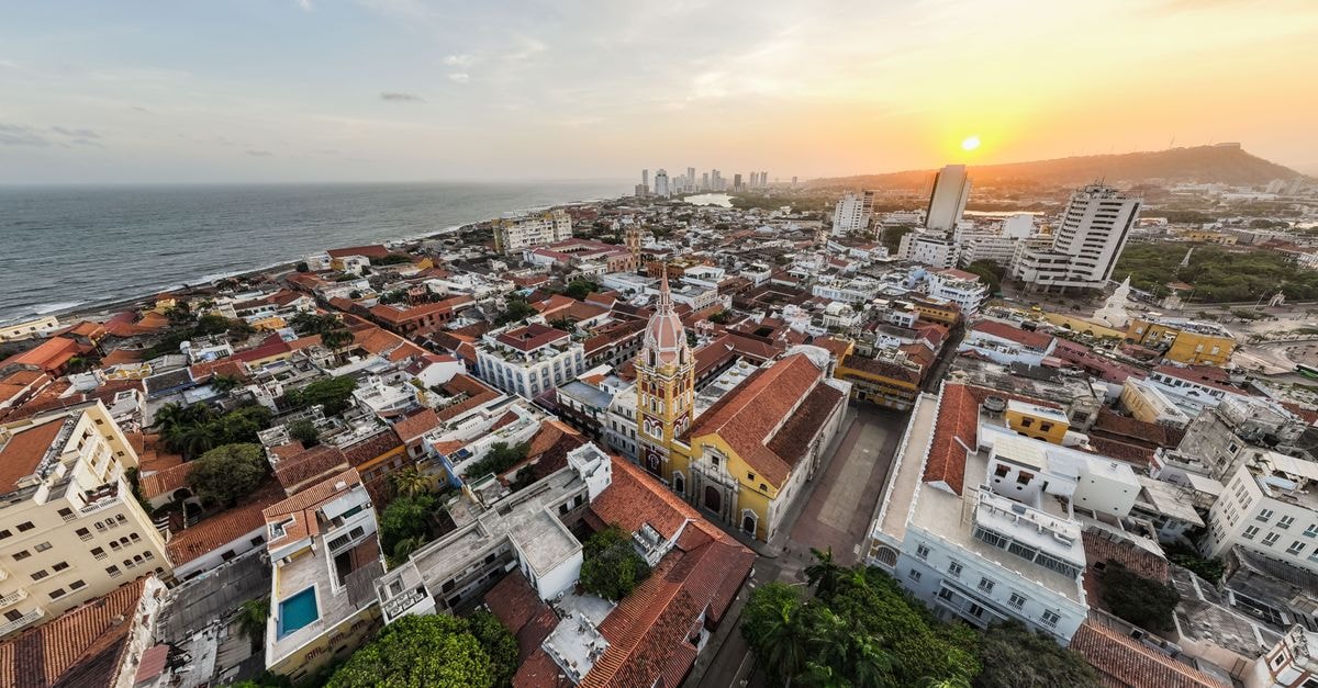 A breathtaking aerial shot of Cartagena's historic district at sunset with vibrant architecture and ocean view.