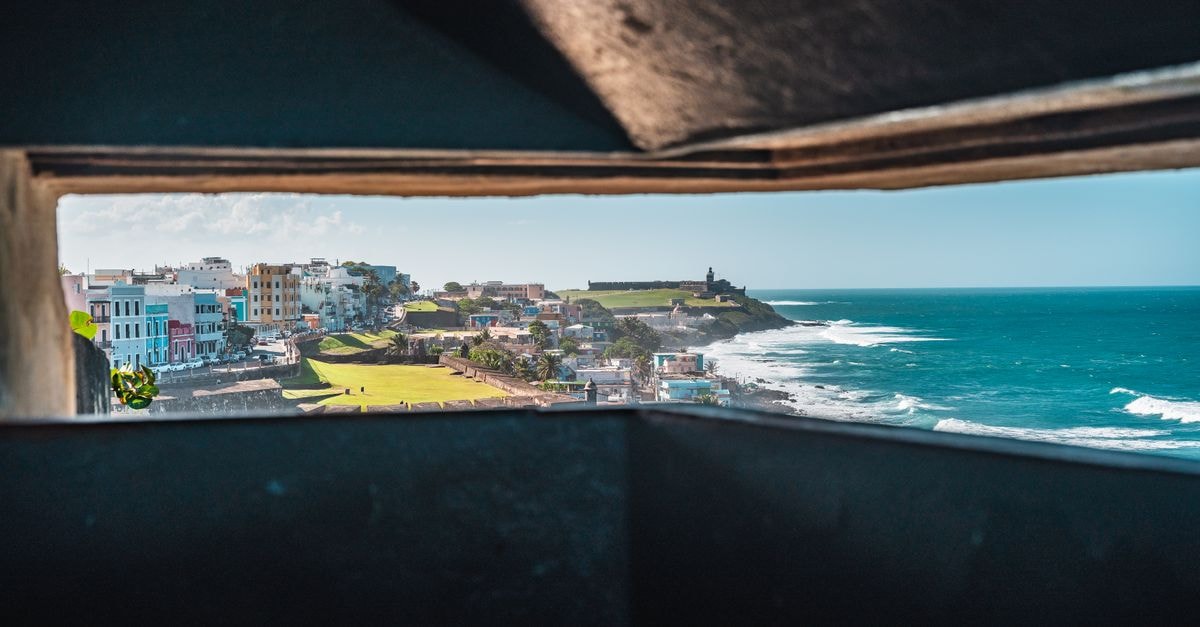 Costa Caribe in San Pedro de Macorís: A Beachfront Address by Guayacanes Scenic view of San Juan's coastal cityscape through fortifications.