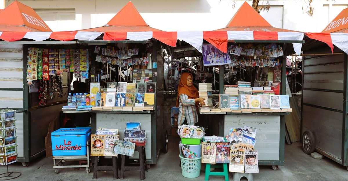 KHAS Malioboro Hotel Yogyakarta: A Central Stay on Jalan Gadean Outdoor book market stall with colorful books and magazines in Yogyakarta, Indonesia.