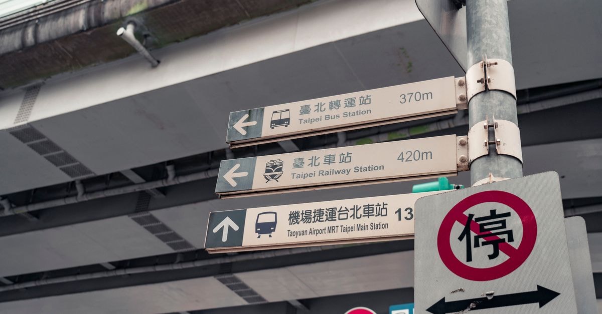 Directional signs showing the way to Taipei Bus and Railway Stations in Taiwan.