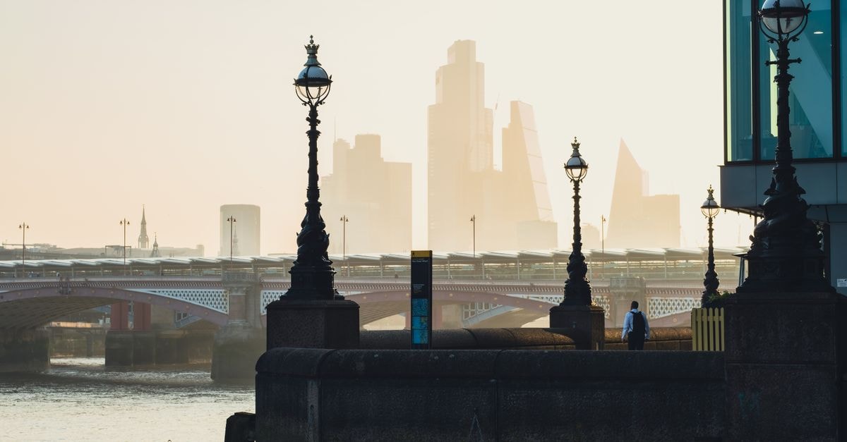 St Martins Lane Hotel in London: A Theatrical Covent Garden Stay City skyline with river and bridge, featuring urban architecture and street lamps in foreground.