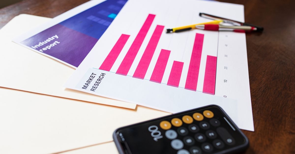 DoorDash’s reported $17 billion Instacart acquisition raises apparel delivery questions Illustrative market research chart and calculator on wooden desk for business analysis.