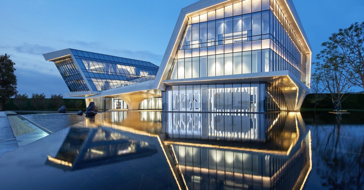 Sleek modern building in China with stunning dusk reflections, showcasing contemporary architecture.
