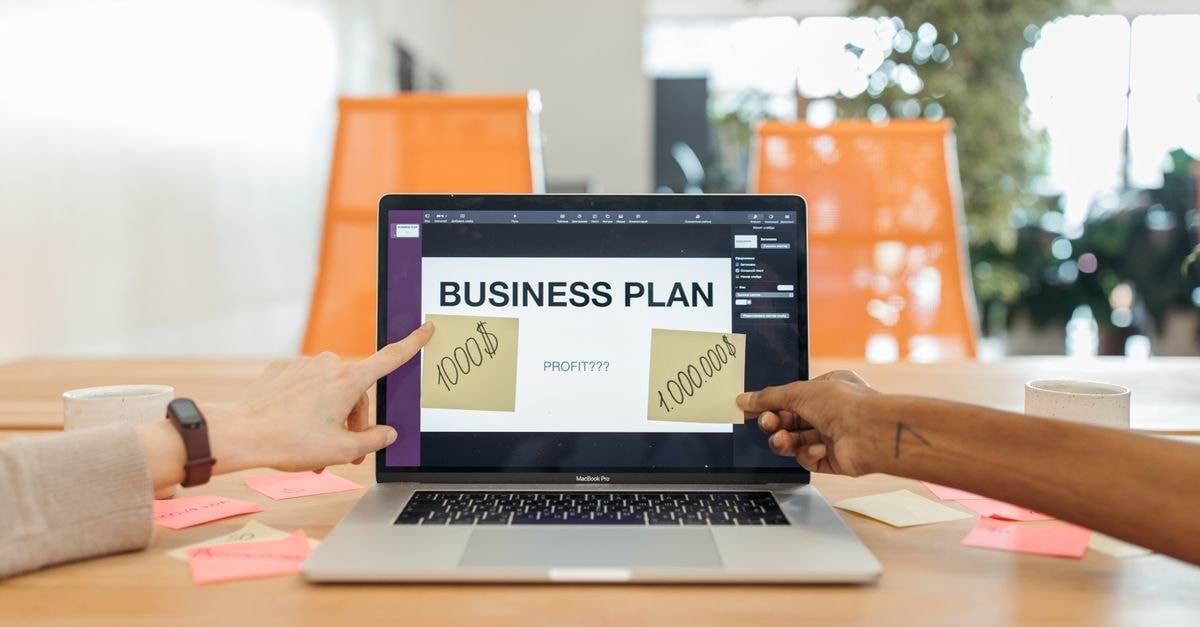 Shopify slides 4–4.6% as profit-taking follows August post-earnings rally Two professionals strategizing a business plan on a laptop with sticky notes and profit goals.