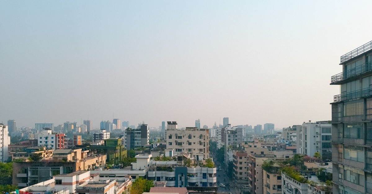Kafrul Travel Guide: An Everyday View of North Dhaka Captivating view of Dhaka's high-rise buildings under a foggy sky, showcasing modern urban architecture.