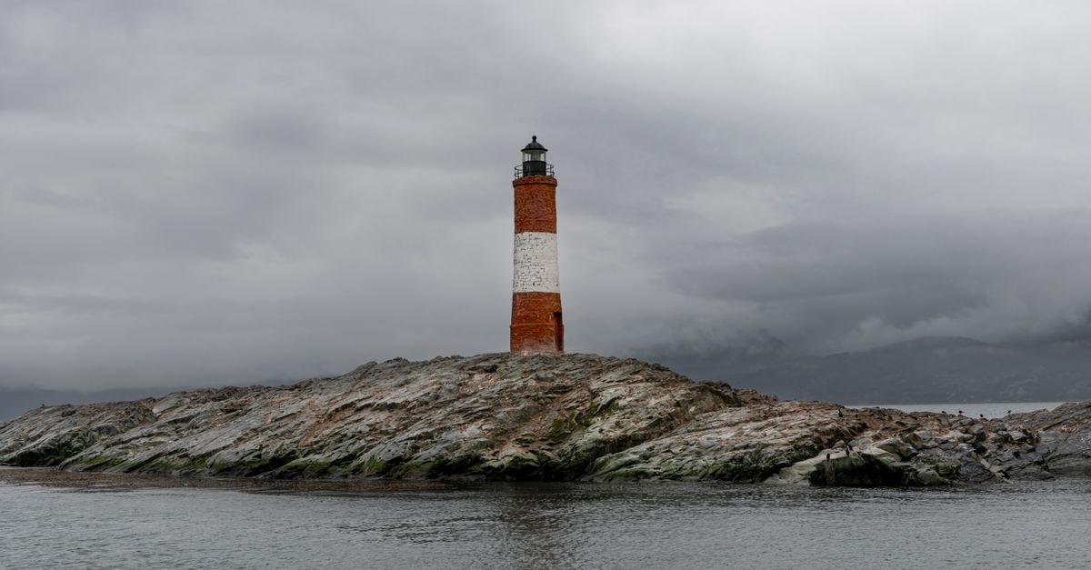 Coyhaique travel guide: a slow week in Patagonia's rainy capital Dramatic view of Les Eclaireurs Lighthouse in Ushuaia, Argentina with stormy skies.