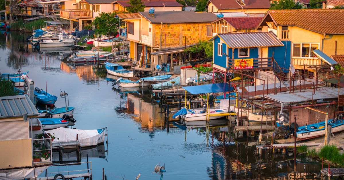 Hotel Bulgaria in Burgas: A 17-Story Stay Overlooking the Bay Tranquil morning view of a traditional coastal village with boats in Burgas, Bulgaria.
