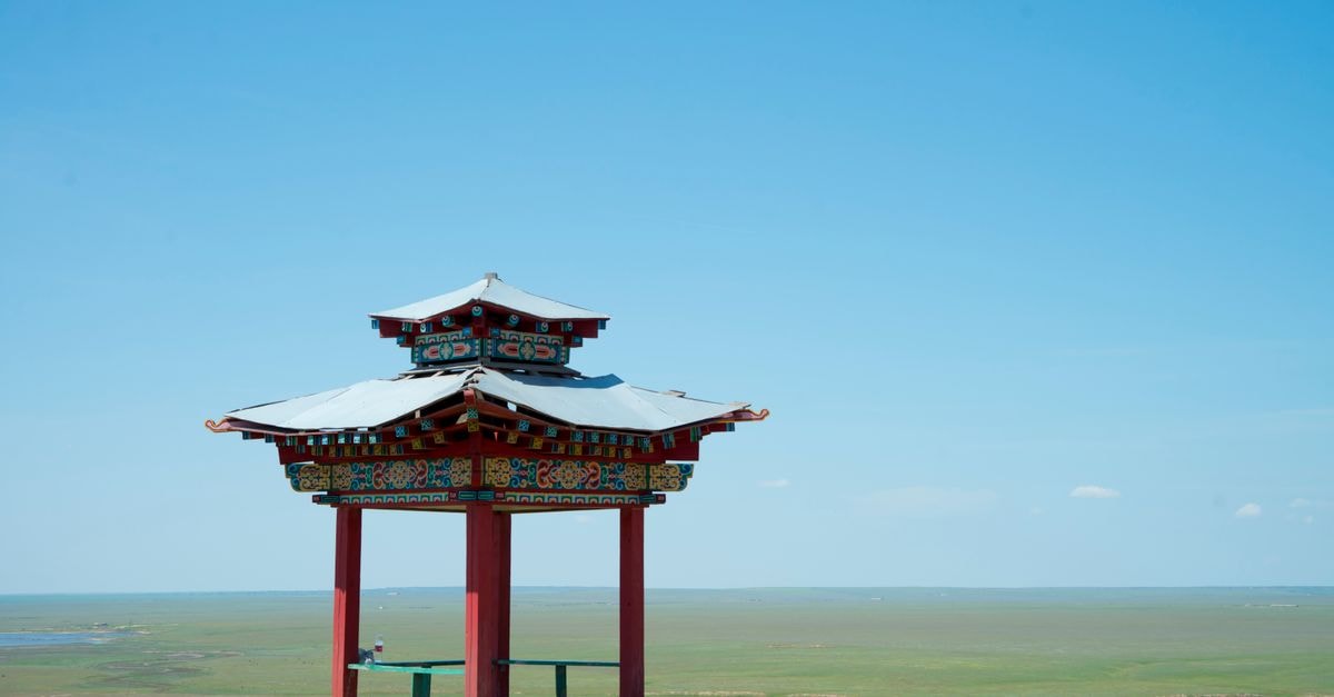 Elista Travel Guide: Steppe Calm and Buddhist Surprises A serene view of a traditional Buddhist pavilion in an open landscape in Kalmykia, Russia.