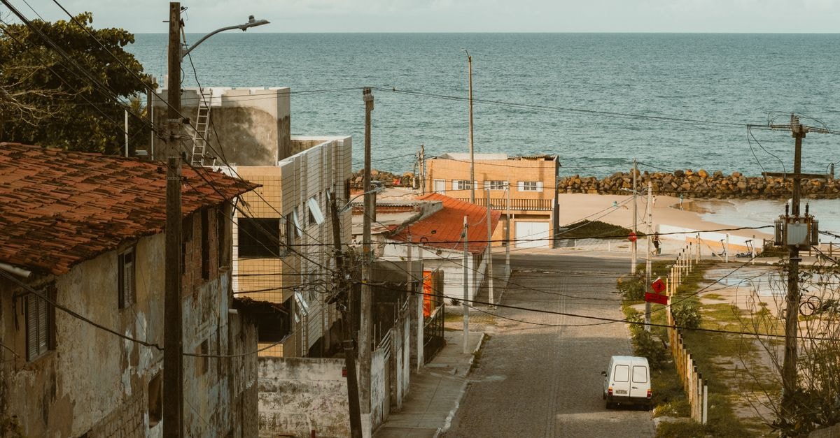 Urban street in Natal, Brazil leading to the ocean, showcasing coastal architecture and vibrant seaside ambiance.