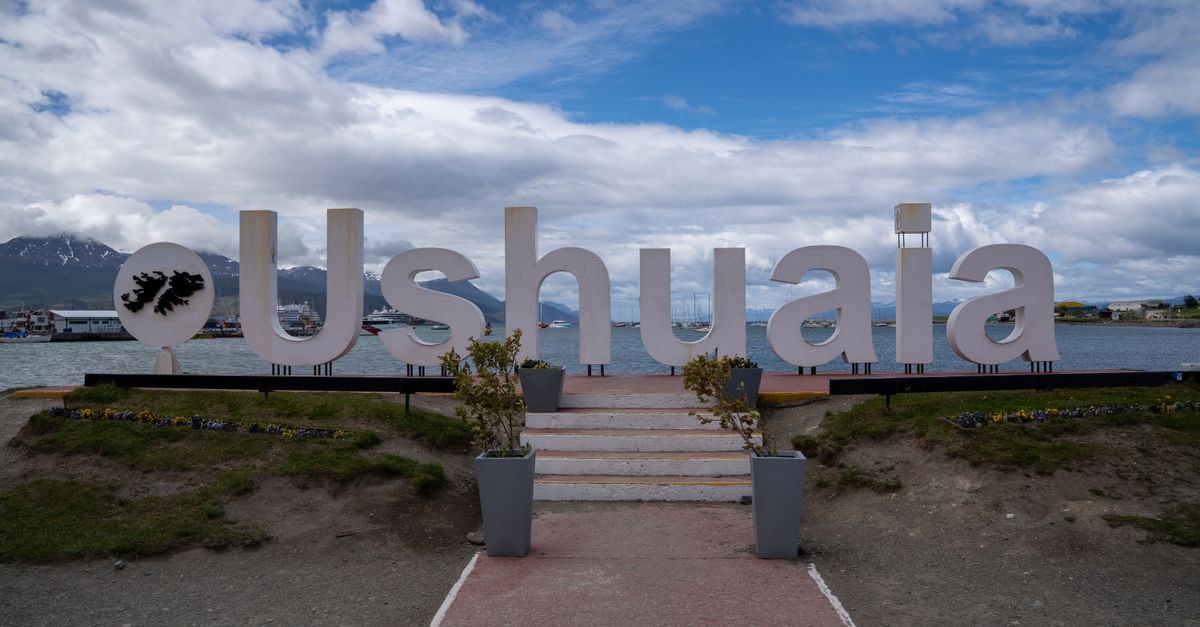 A Quiet Riverside Welcome: A Travel Guide to Viedma Iconic Ushuaia sign in Argentina with stunning mountain and sea view.