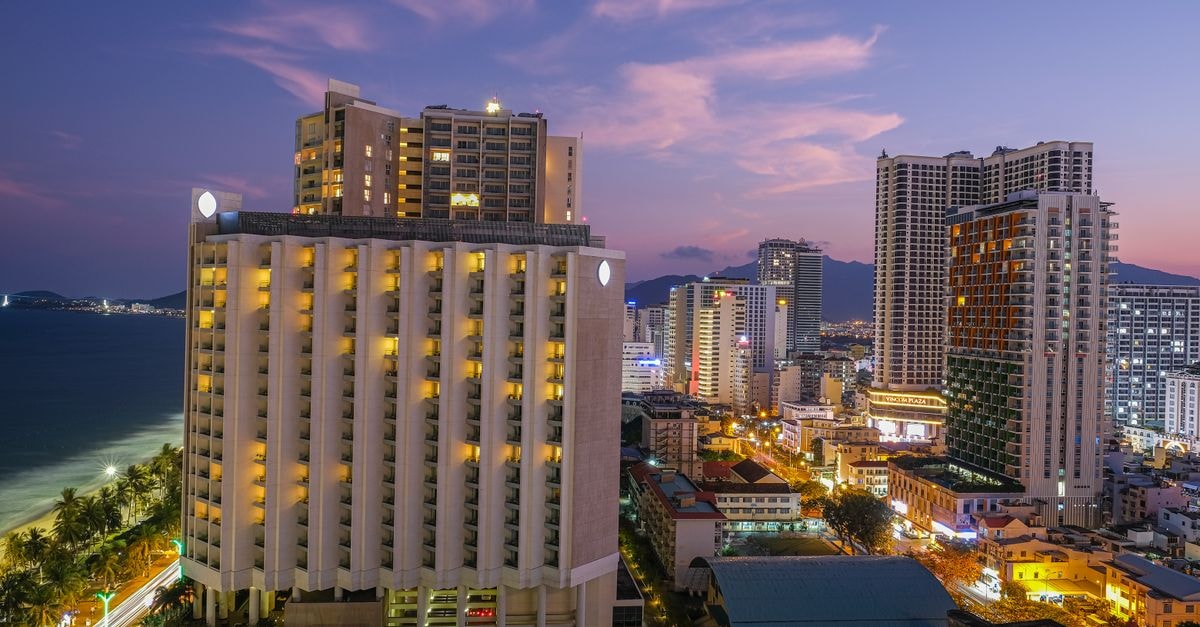 InterContinental Nha Trang, Nha Trang — Beachfront Escape on Tran Phu Picturesque view of modern city with glowing lights and skyscrapers in night time under scenic sky