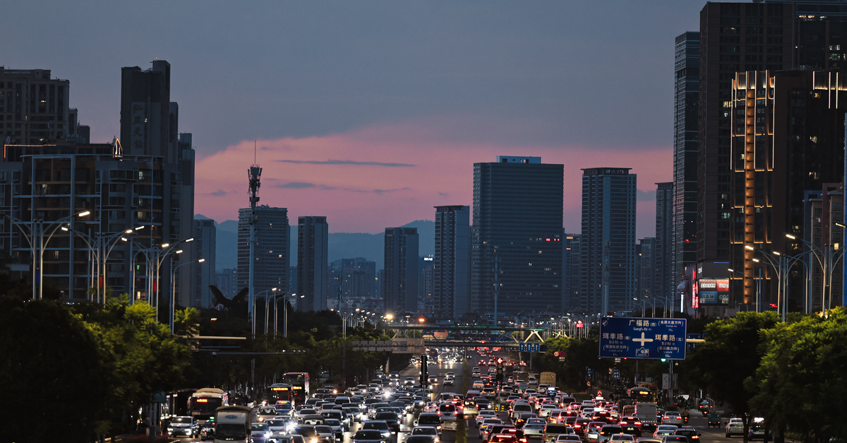 Micron slides as chip rout spreads on China DUV breakthrough report City street bustling with traffic against a twilight skyline, capturing urban life.