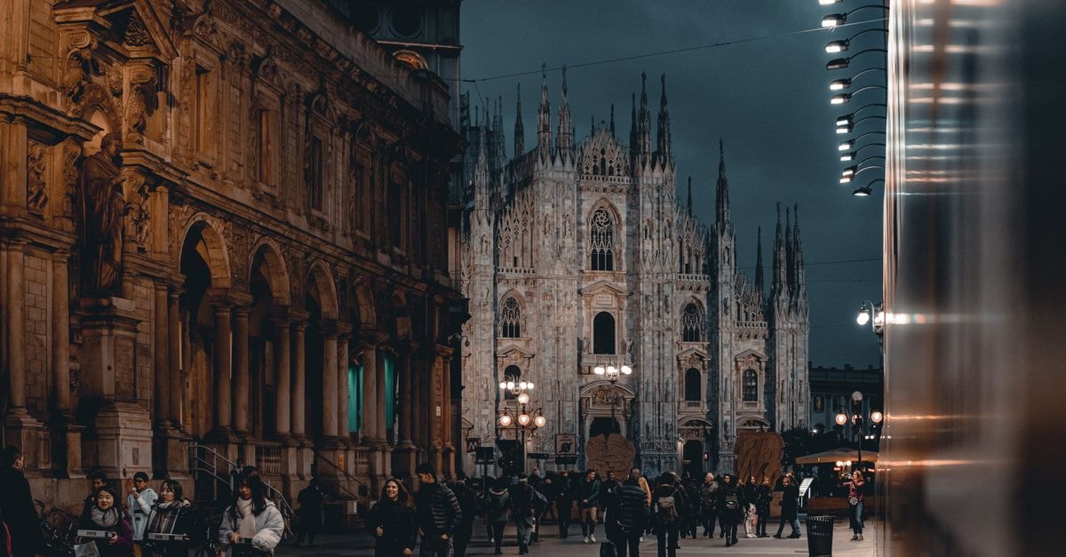 Hotel Spadari al Duomo, Milan — Art, Design and a Few Steps from the Duomo Night scene of Milan's Duomo with people and city lighting, showcasing historic architecture.