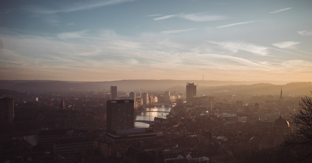 Hôtel Ibis Styles Liège Guillemins: BD-Inspired Stay by Liège-Guillemins Station Scenic view of Liège with warm sunset hues reflecting over the Meuse River.