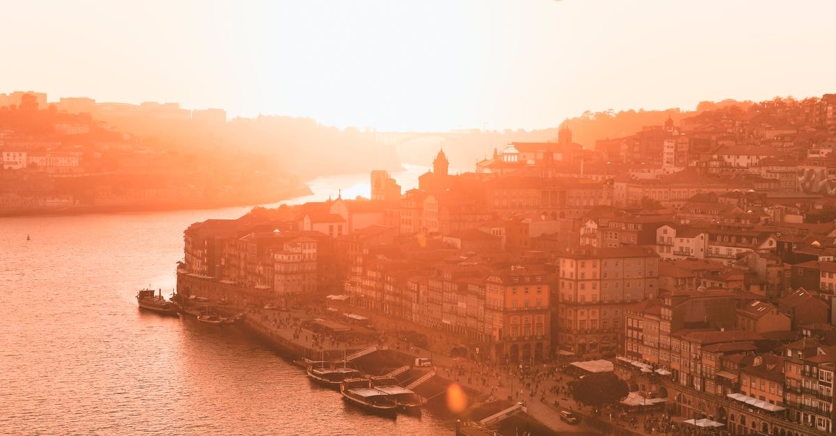 The One Monumental Palace, Porto: A 1923 Neoclassical Landmark on Avenida dos Aliados A stunning sunset over the Porto waterfront, capturing the city's iconic riverside view and historical architecture.