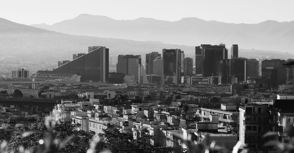 Luxury Art Resort Galleria Umberto I, Naples: Inside a 19th-Century Shopping Gallery Aerial view of Naples cityscape with iconic skyline and Mount Vesuvius in the background.