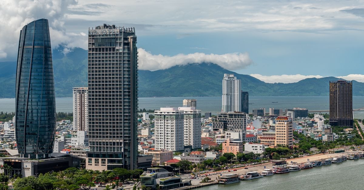 Sanouva Danang Hotel in Da Nang: Heritage Building with a Library-Inspired Boutique Stay Beautiful view of Da Nang skyline featuring modern skyscrapers and coastline.