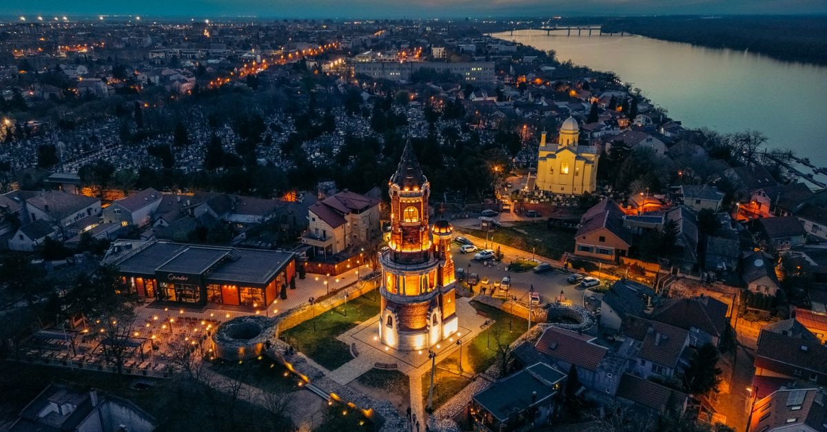 Breathtaking aerial view of Gardoš Tower illuminated at twilight in Belgrade, Serbia.