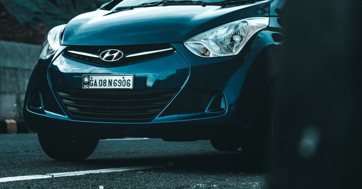 Front view of a Hyundai vehicle parked on an asphalt road.