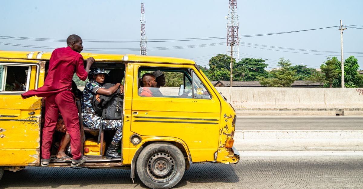 Abobo, Abidjan: A Practical Travel Guide to Everyday Ivorian City Life A yellow crowded commuter van with passengers on a sunny urban road.