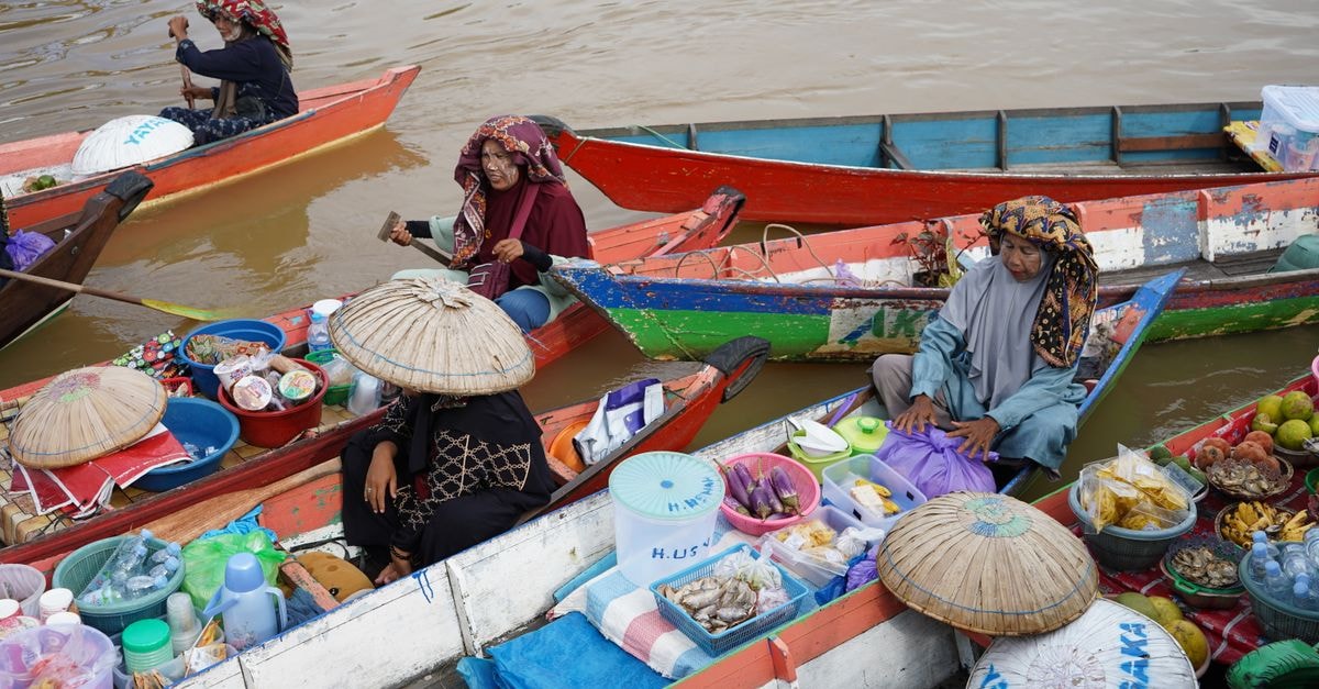 Colorful scene of a traditional floating market with vendors selling goods from boats.