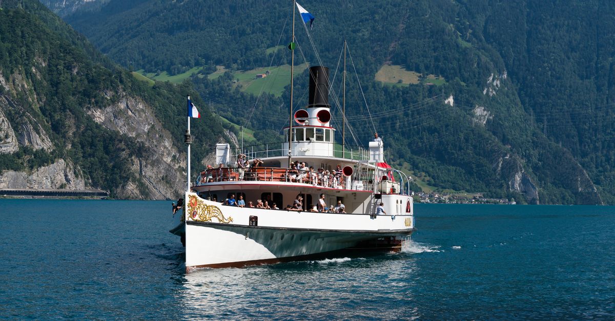 Lucerne Travel Guide for July 2026: Weather, Summer Festivals, and Mountain Day Trips Historic paddle steamer cruising on Lake Lucerne in the Swiss Alps, surrounded by picturesque mountains.