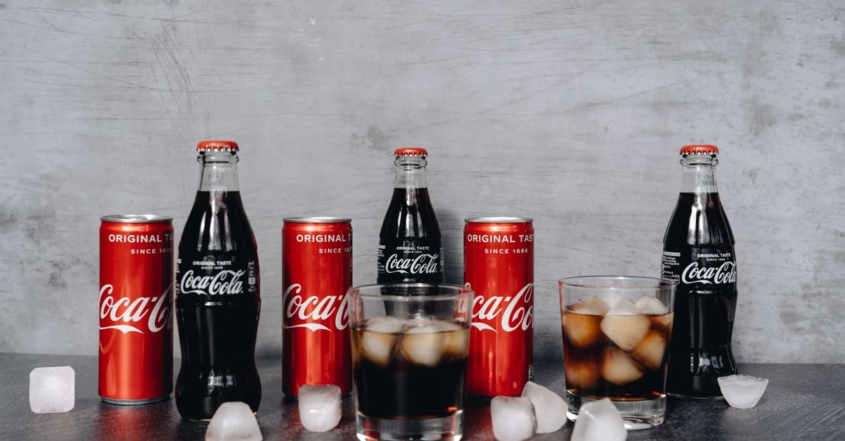 Coca-Cola Consolidated: A Capital-Intensive Bottler Without a Moat of Its Own Chilled Coca Cola bottles and cans surrounded by ice cubes, offering a refreshing beverage choice.