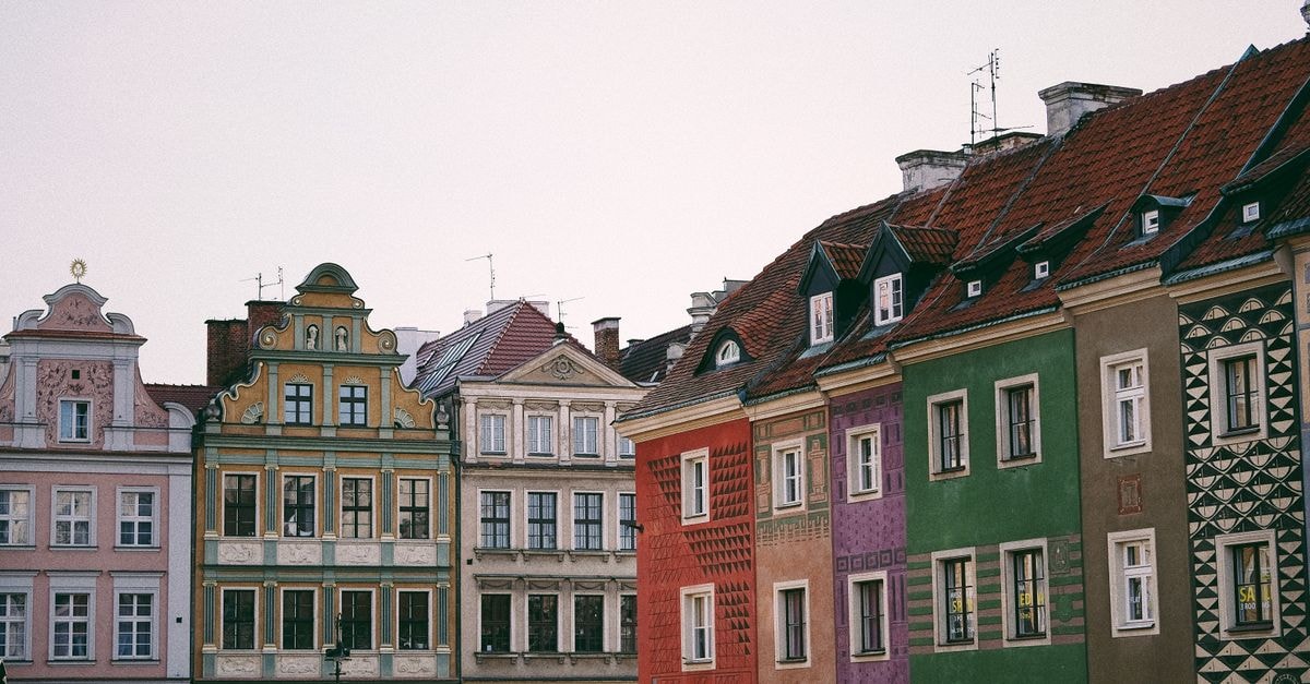 Hostel Stonewall, Poznan — A Klasztorna 2 Address Worth Knowing Vibrant facades of historic buildings in Poznań's Old Market Square showcase classic European architecture.