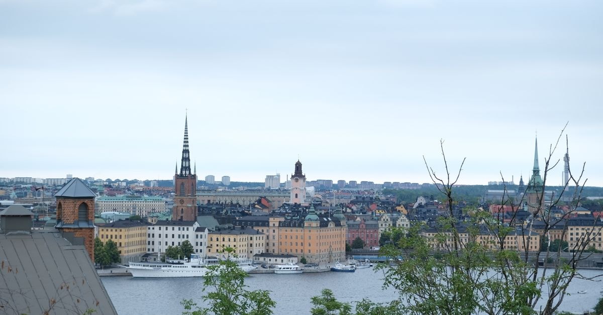 Hôtel Reisen in Stockholm: Historic Old Town Stay by Hyatt's Unbound Collection A stunning aerial view of Stockholm's historic architecture and waterways under a cloudy sky.
