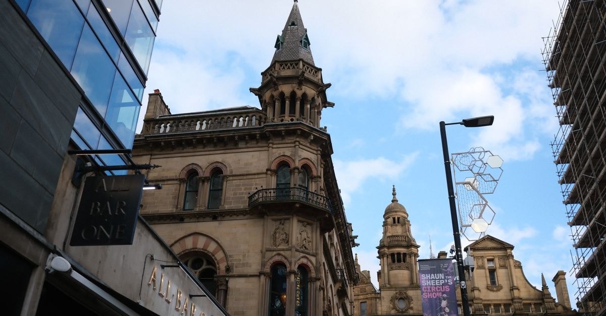 Sheffield Travel Guide: Planning Tips, Costs and Things to Do Street view focusing on charming Victorian-era architecture with a clear blue sky as the backdrop.