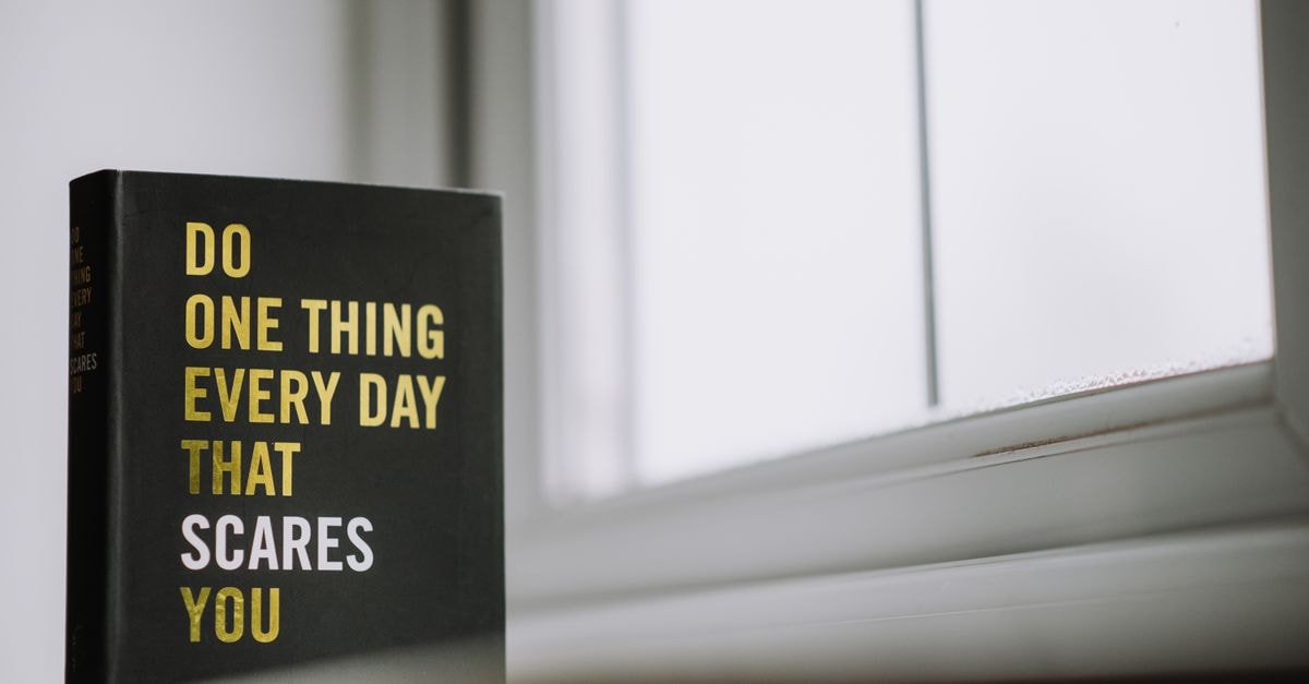 Things to Do in Kansas City: A Calm Creator's City Guide Rectangular shaped book with printed title on black hardcover on windowsill in house in daytime