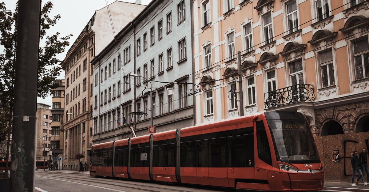 Hotel Zlami-Holzer, Klagenfurt — Family-Run Stay in the Old Town Core Explore the charm of Bratislava's streets with this classic view of a red tram passing by historic facades.