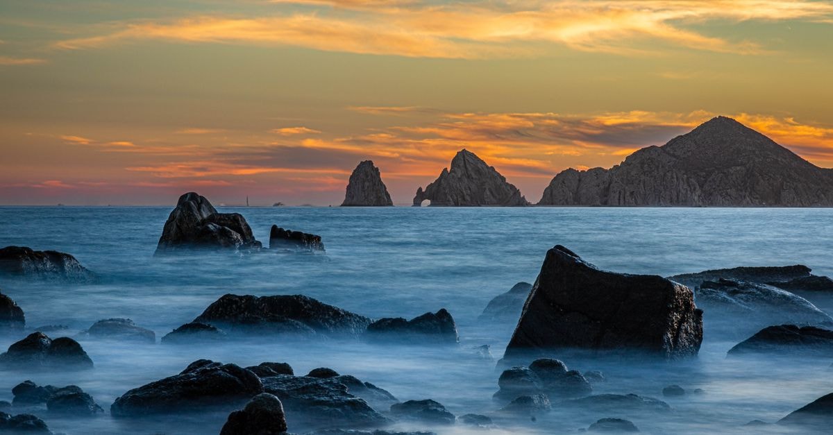 605 Tower Downtown Cabo in Cabo San Lucas: Boulevard Living in the Heart of Centro Stunning long exposure of rocky seascape at sunset in Cabo San Lucas, Mexico.
