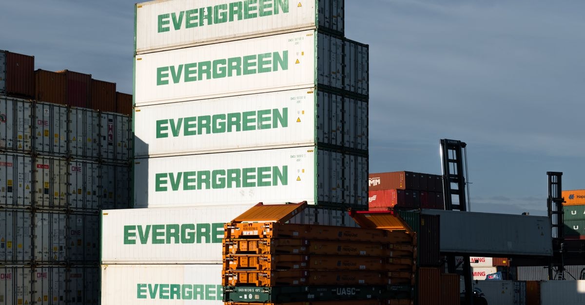 Expeditors International: A Non-Asset Logistics Network Whose Price Already Bakes In Steady Growth A stack of Evergreen cargo containers at Hamburg port, showcasing industrial logistics.
