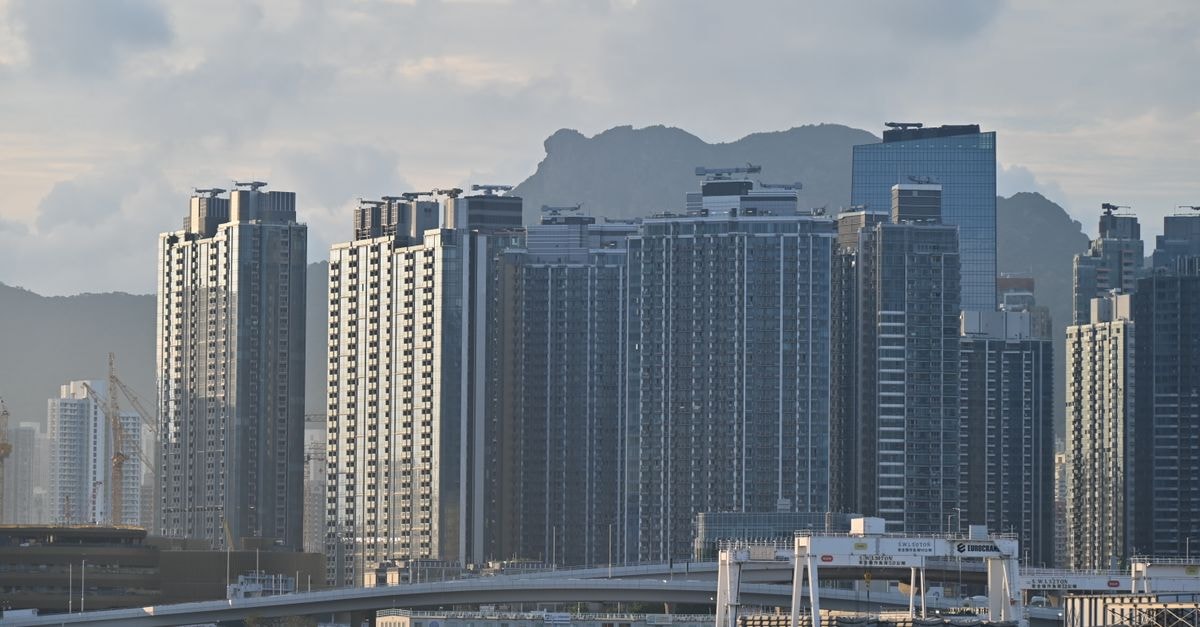 Shama Hub Metro South Hong Kong: Apartment-Style Living in Wong Chuk Cityscape featuring towering high-rise buildings against a mountainous backdrop.