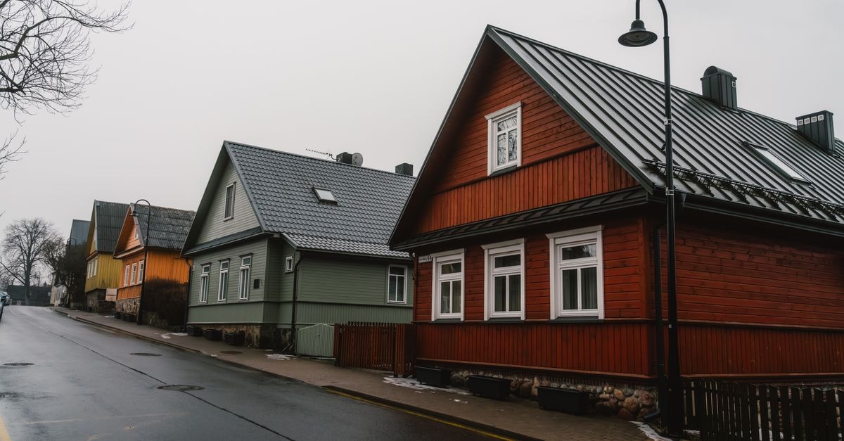 A Quiet Northern Lithuania: Utena Travel Guide Scenic view of a peaceful European street with colorful wooden houses on an overcast day.