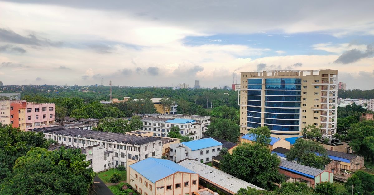 STA Hall, DUET, Gazipur: A Student Residence on the Dhaka University of Engineering & Technology Campus Aerial view of city buildings and greenery under a cloudy sky.