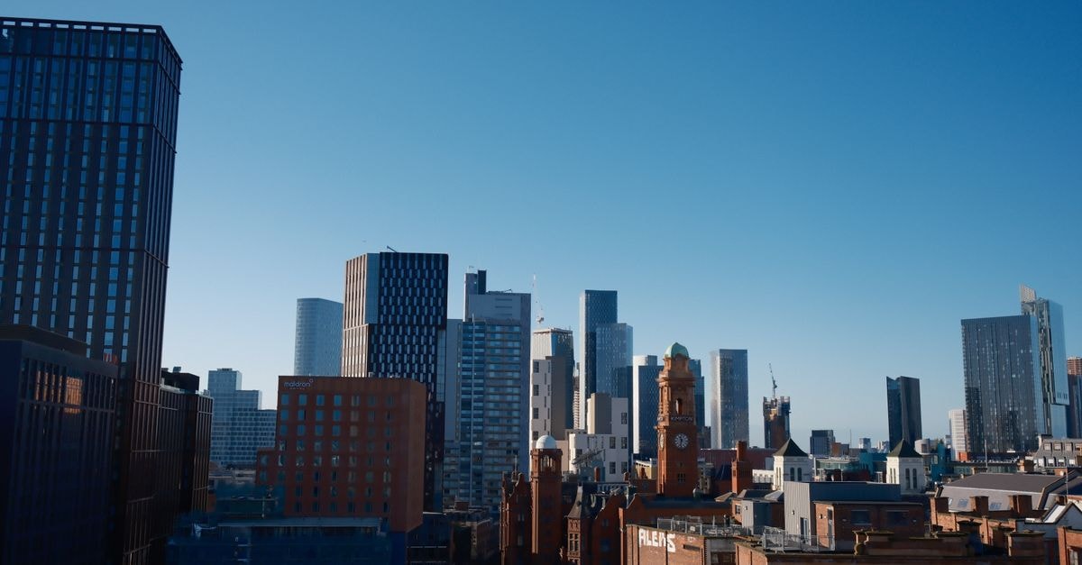 Malacuna in Manchester: A Northern Quarter Hostel With a Community Vibe Skyline of Manchester city featuring the iconic Beetham Tower under a bright blue sky.