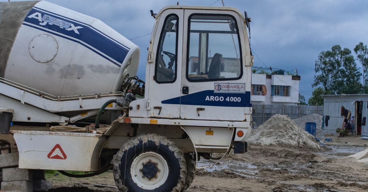 Astec Industries: Acquisitions Drive Growth, But Price Already Bakes In Optimism Close-up of a concrete mixer truck at a construction site under cloudy skies.