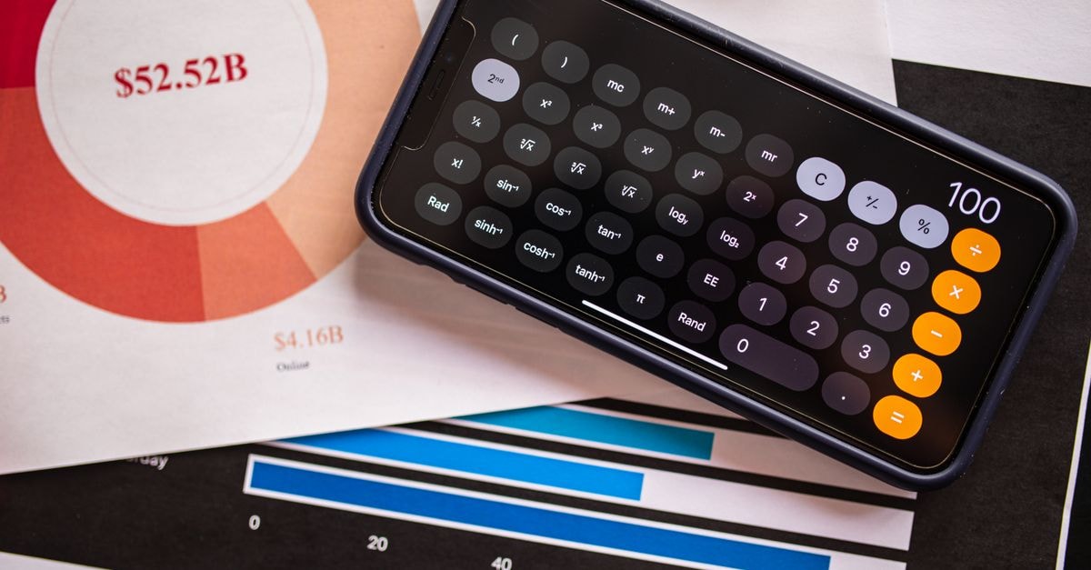 Qualcomm hikes chip prices and warns of Apple modem revenue plunge as data center bets ramp A smartphone displaying a calculator app on financial charts, showcasing revenue analysis.