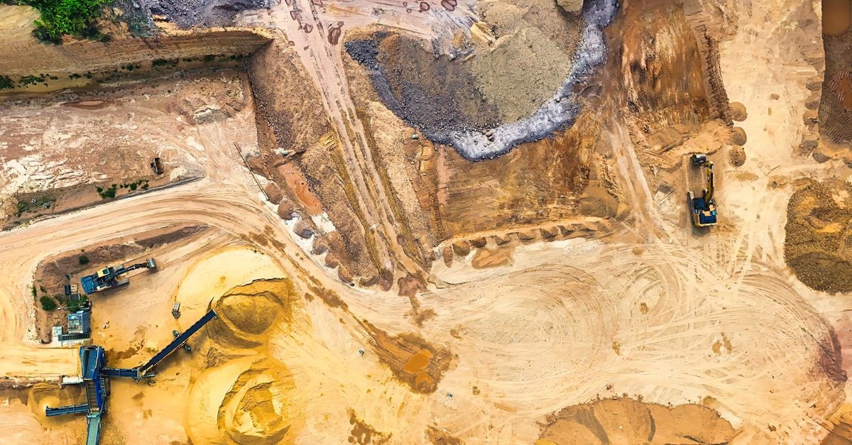 Bridge Green Upcycle signs commercial agreement with Hartree Partners for lithium carbonate supply Aerial view of a sand quarry with machinery, showcasing extraction and mining.
