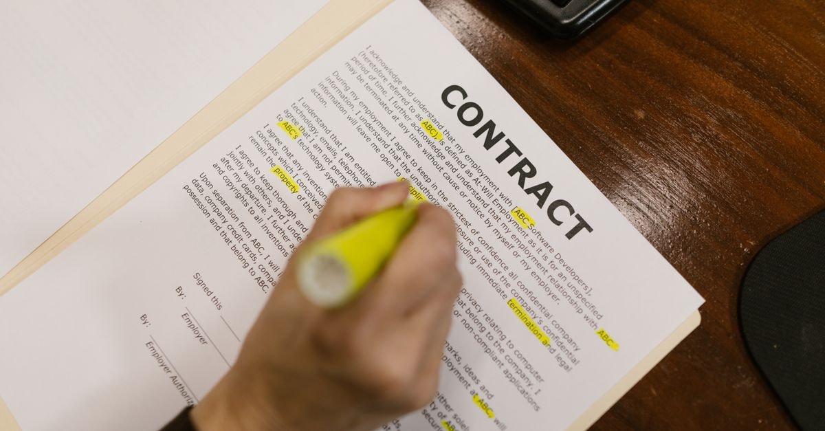 Walmart Labor Day 2026 Deals Span Apple, KitchenAid and Toys as Low as $7 Focused view of a person highlighting text in a contract document on a wooden office desk.