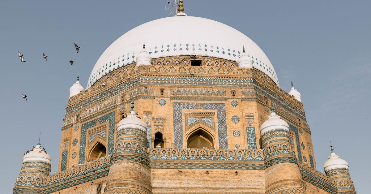 The First Hotel Multan: Government-District Convenience on Kaswar Gardezi Road The stunning architectural details of the Tomb of Shah Rukn-e-Alam in Multan, Pakistan under a blue sky.