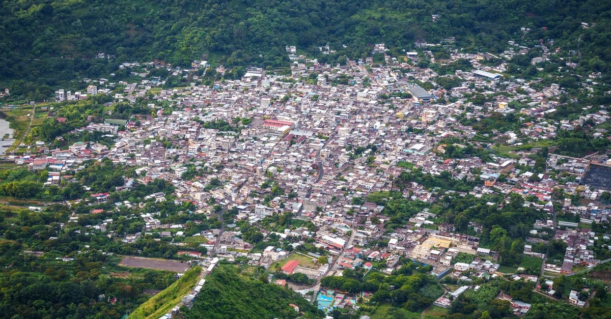 A stunning aerial shot of San Juan La Laguna, showcasing its vibrant town layout nestled in lush greenery.