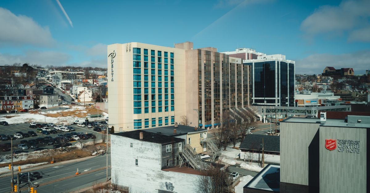 Gower Manor in St. John's: A Four-Floor Victorian Home Aerial view of a winter cityscape with Delta Hotel and the Centre of Hope under a clear blue sky.