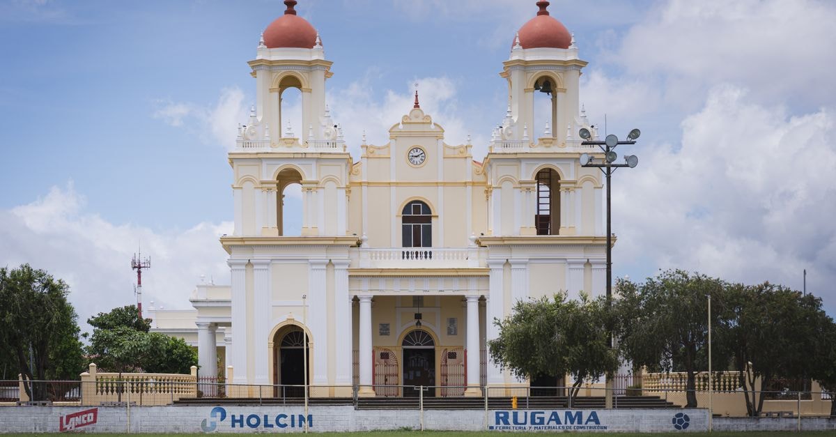 A beautiful view of a historic church in Santo Domingo, Heredia, Costa Rica, under a bright sky.