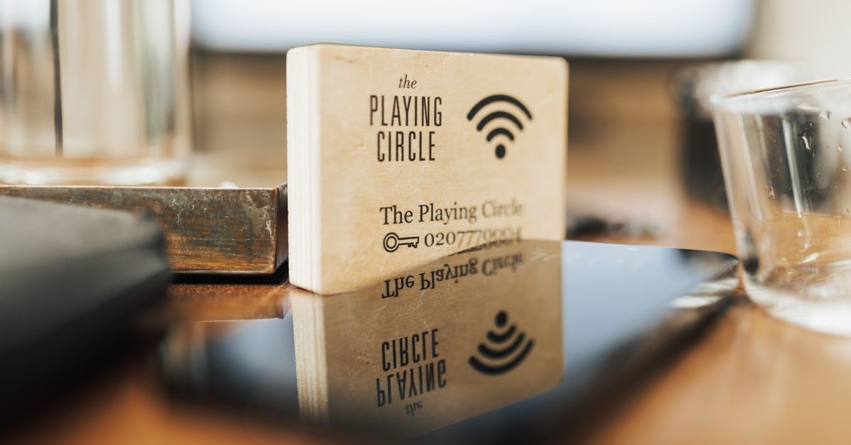 Comcast launches Xfinity Shield, adding network-level cybersecurity and home monitoring to Xfinity Wi-Fi A wooden block displaying Wi-Fi details sits on a modern office desk.