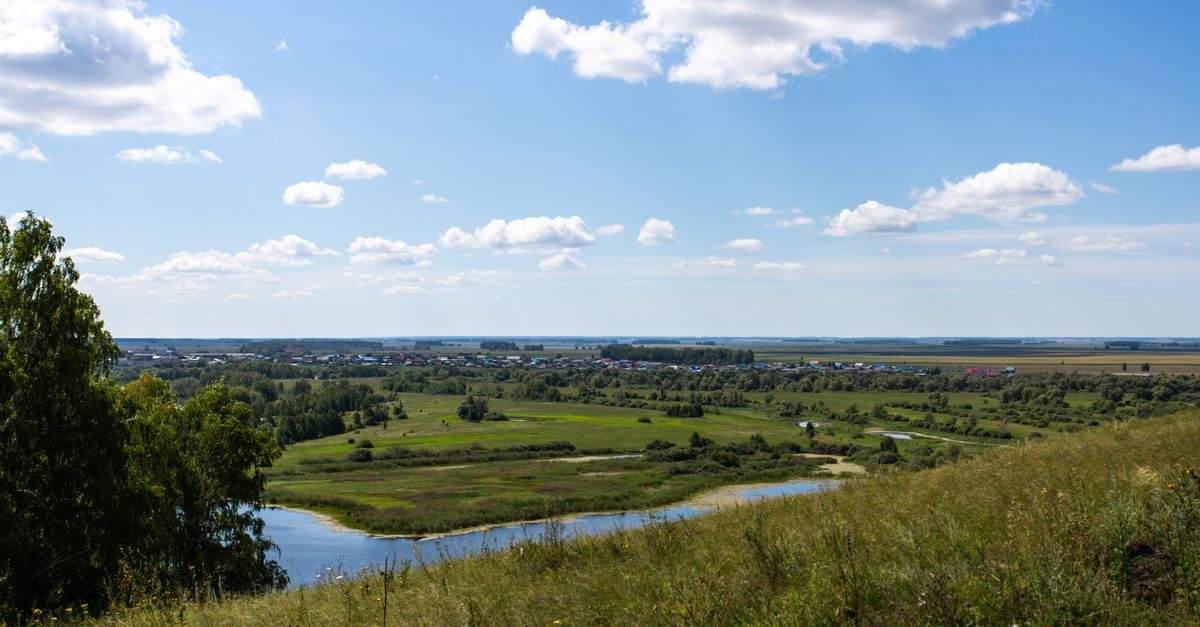 Eurasia Hotel, Tyumen: A Business Hotel on Sovetskaya Street Beautiful summer landscape in Ishimsky District, featuring a river, fields, and a clear sky.